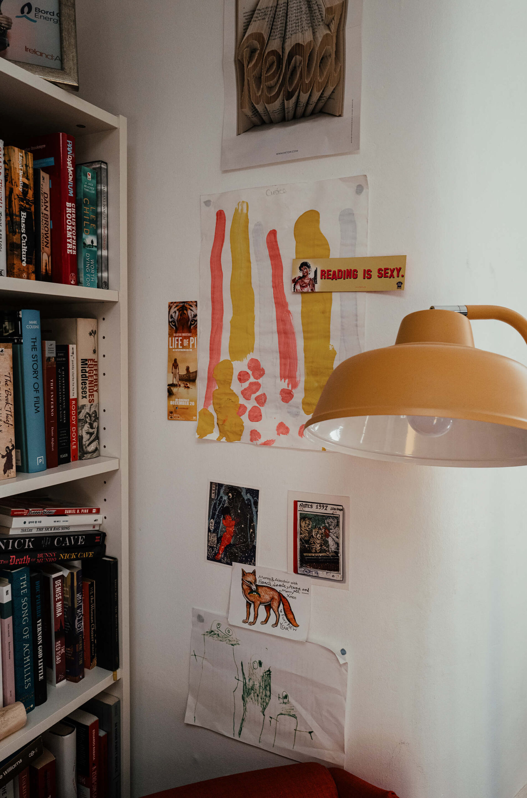 A photo of a wall and some shelves in the Canongate office